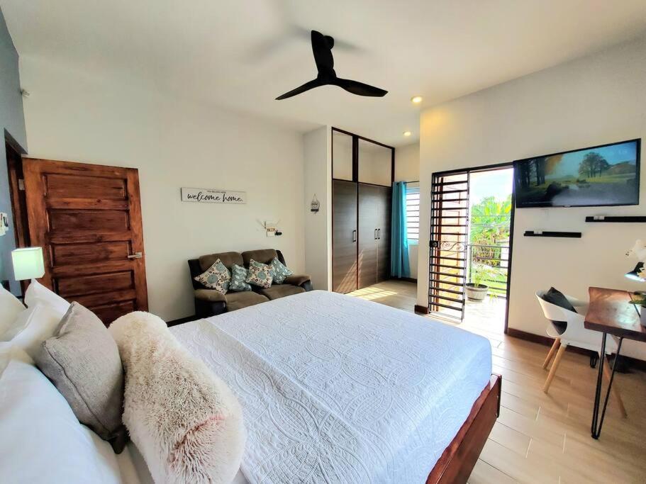 a bedroom with a bed and a ceiling fan at 'The Solace' New Luxury Modern 1Bed 1Bath Apt. in Portmore