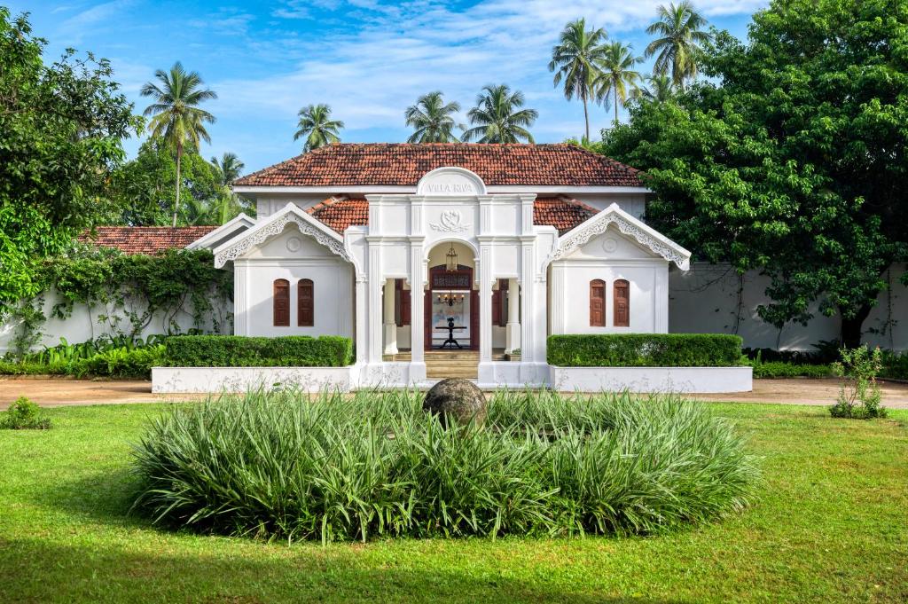 a white house with a red roof at Uga Riva - Negombo in Negombo