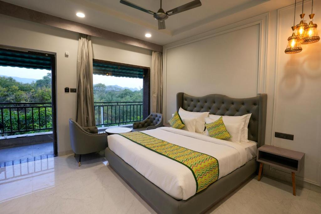 a bedroom with a large bed and a balcony at Bageecha Resort in Pushkar