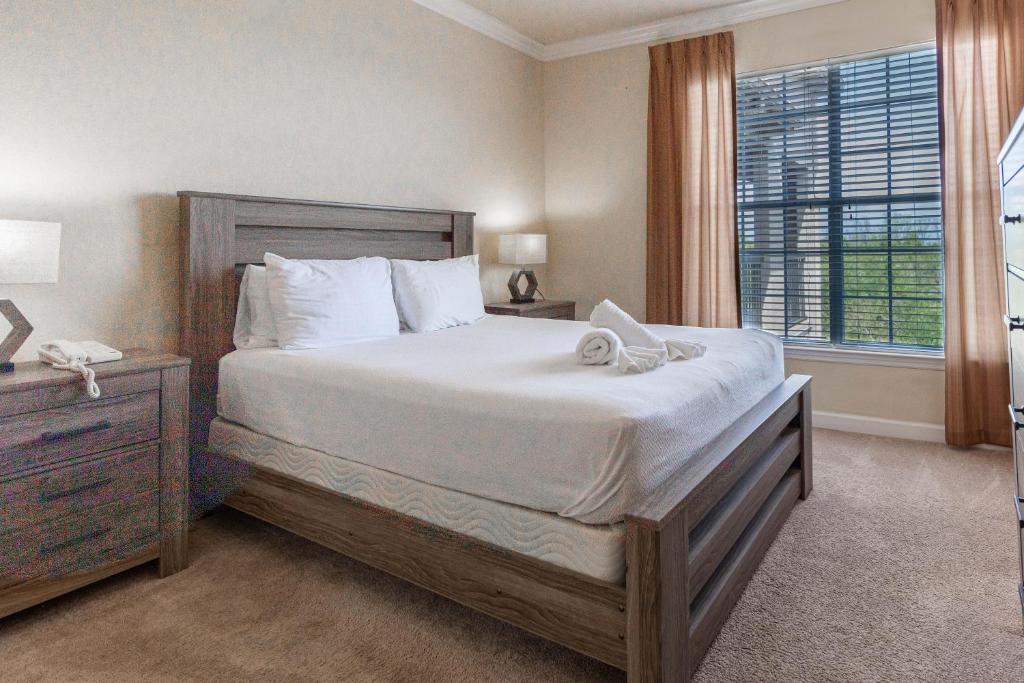 a bedroom with a large bed and a window at 8000TW Unit 4403- Tuscana Resort in Kissimmee