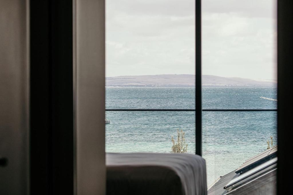 a room with a view of the ocean through a window at Met Apartments in Port Lincoln