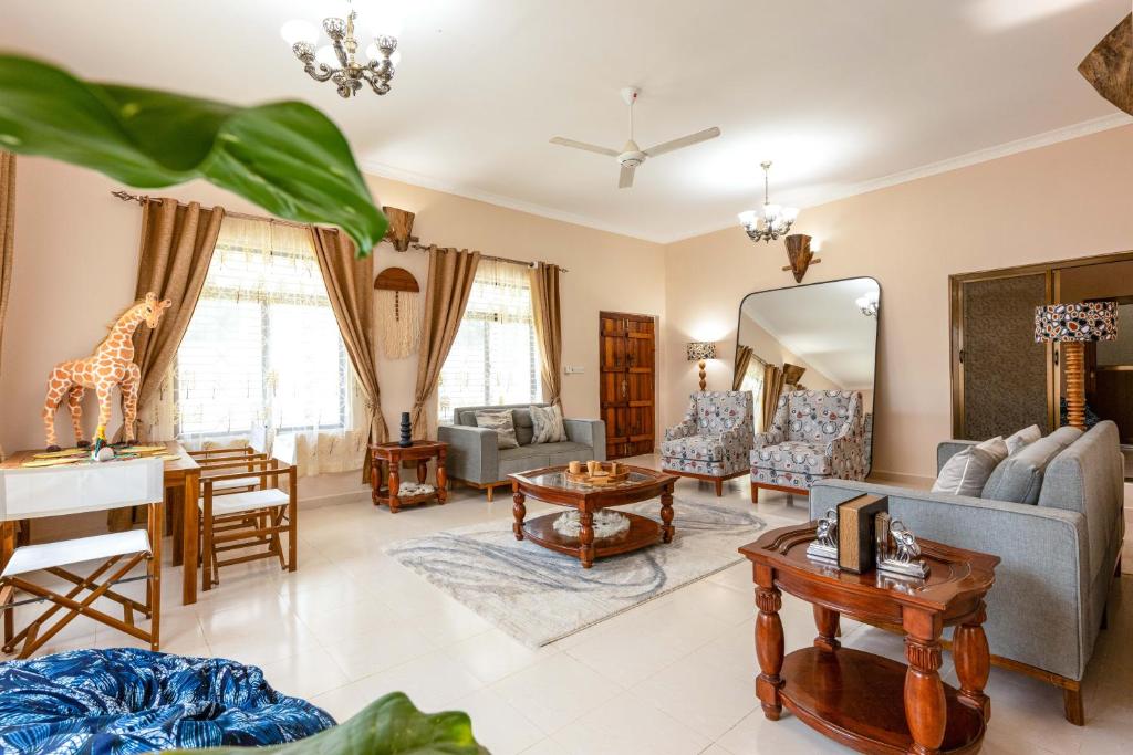 a living room with a giraffe in the middle at Shivo Guest House in Kiembi Samaki