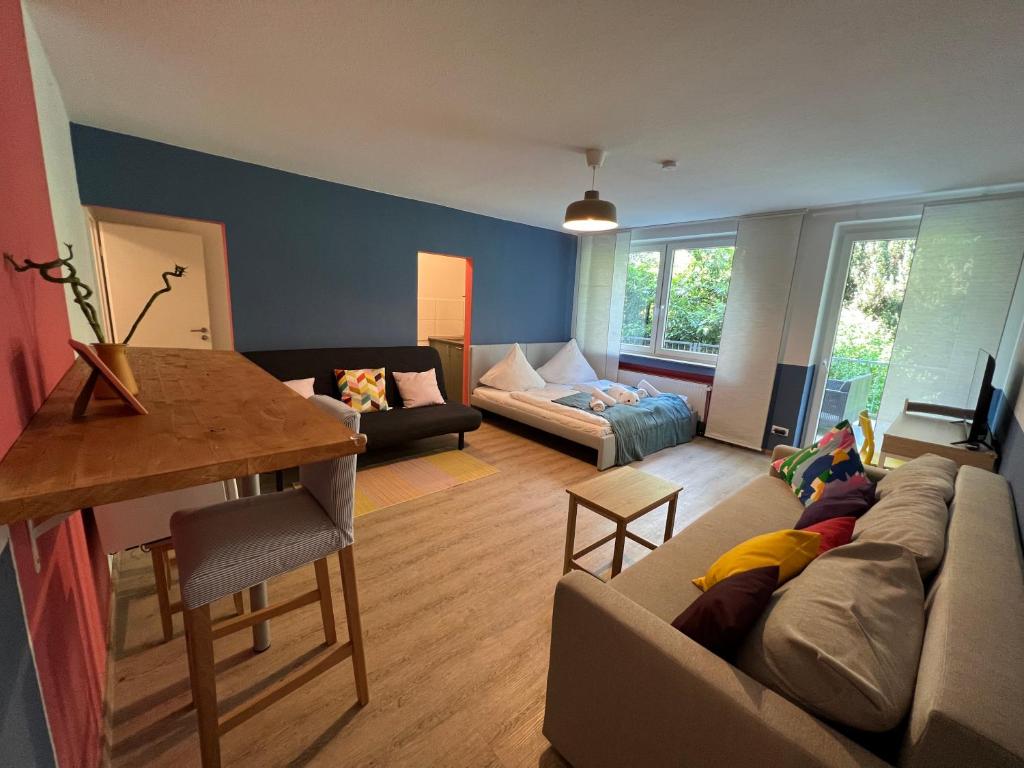 a living room with a couch and a table at Central apartment with Terrace and a free parking in Duisburg