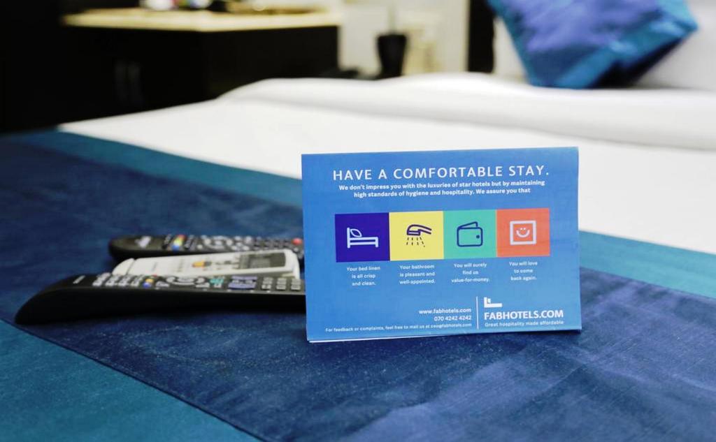 Una cama o camas en una habitación de FabHotel Prime Shree Dev Prime