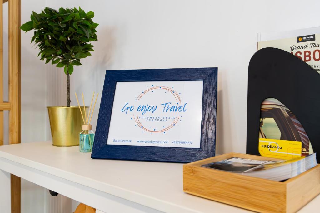 a table with a picture and a box on it at AL d' Cacilhas Studio in Almada