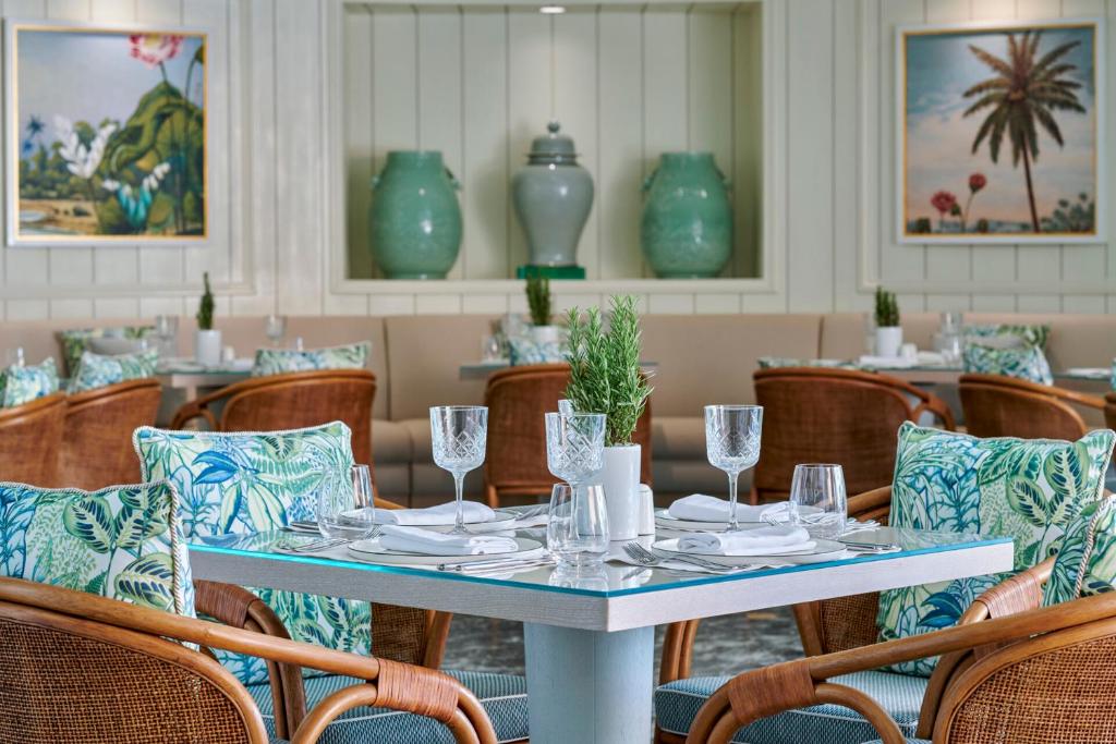 a table and chairs in a restaurant with blue vases at Four Seasons Hotel Cairo at Nile Plaza in Cairo