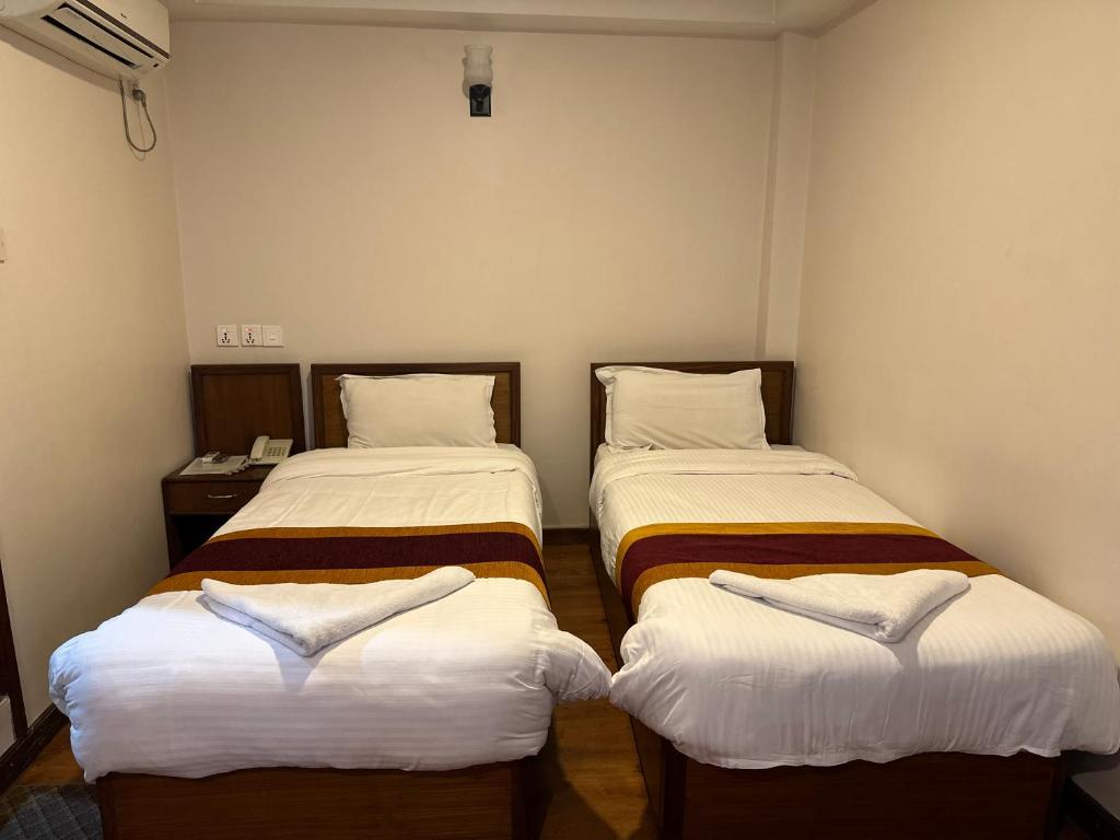 Postel nebo postele na pokoji v ubytování Hotel Everest Nepal