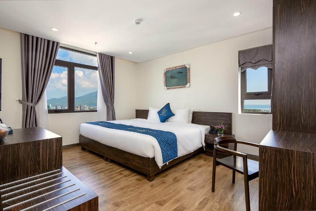 Postel nebo postele na pokoji v ubytování Sepon Blue Hotel