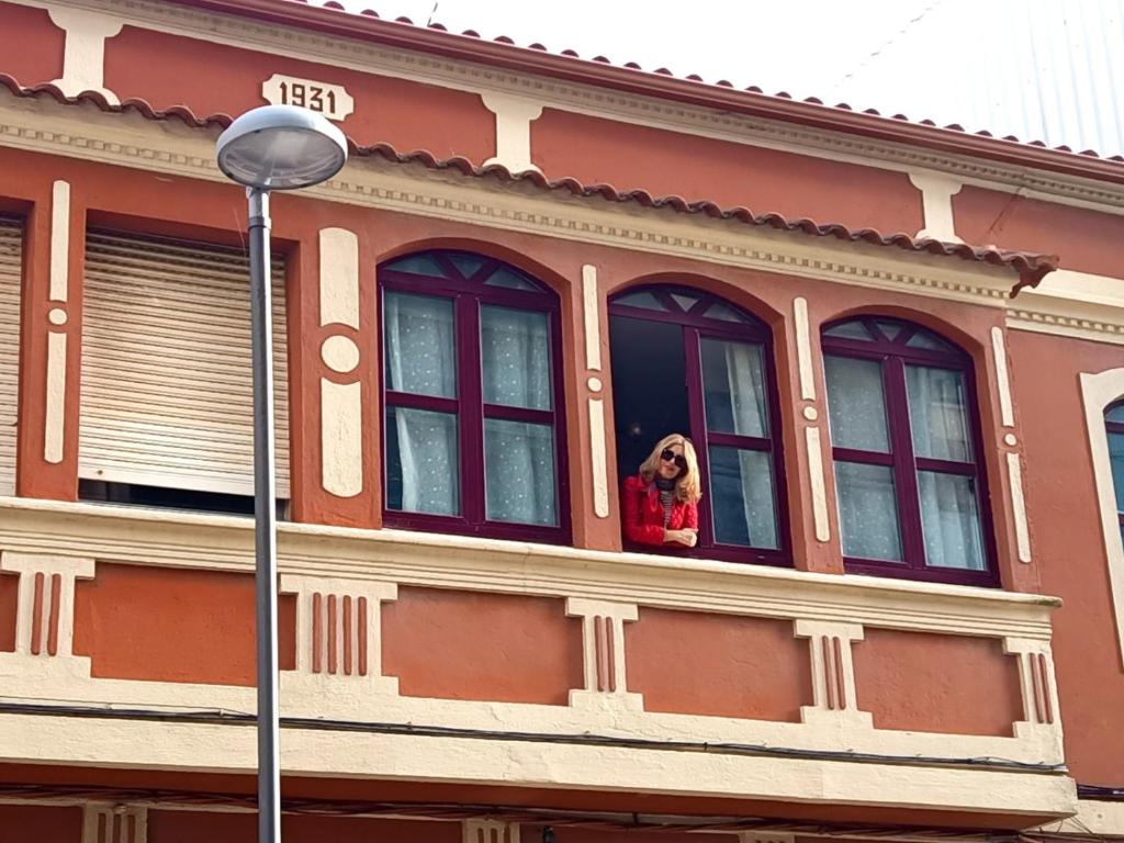 a dog looking out of the window of a building at Atico maravilloso en Cangas , Vigo in Cangas de Morrazo