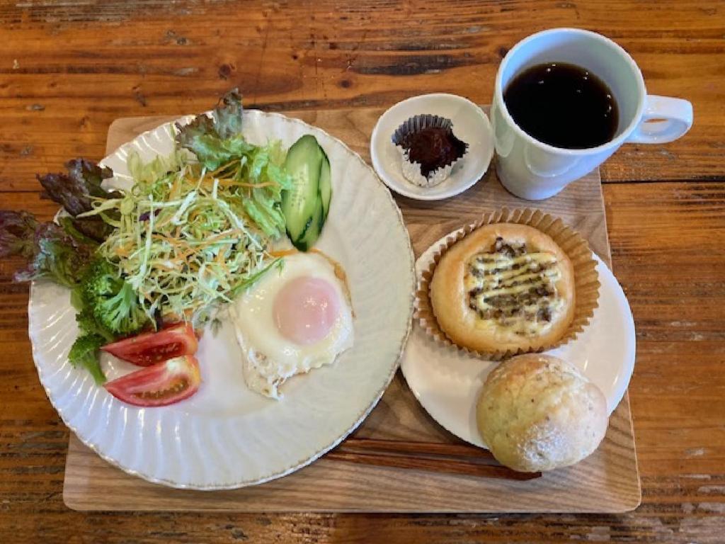a table with two plates of food and a cup of coffee at Female Only Dormitory Guest House Amami Long Beach 2 Breakfast included- Vacation STAY 64534v in Amami