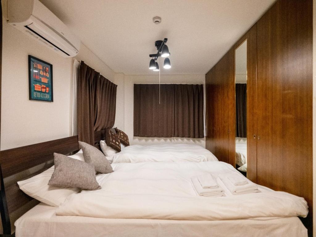 a large bedroom with two beds in it at Sumiyoshi Marie - Vacation STAY 12161 in Osaka