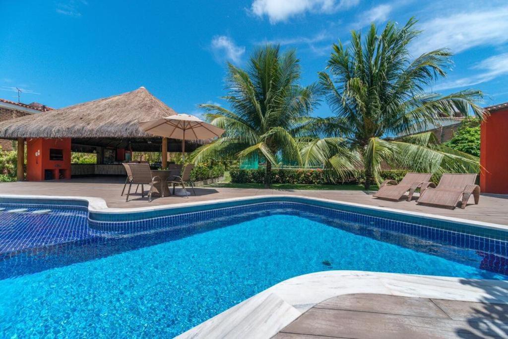 a swimming pool in front of a villa at Casa de praia completa in Paulista