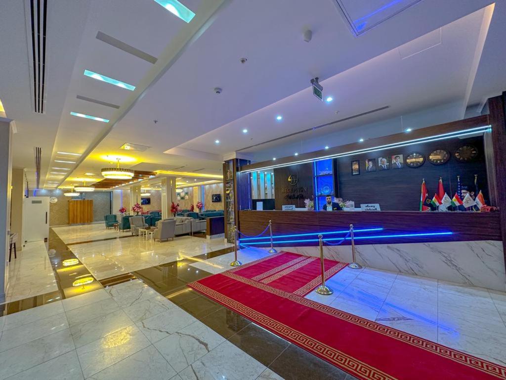 a lobby with a swimming pool in a building at Hotel Chanel Plaza in Erbil