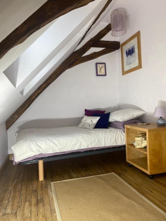 a bedroom with a bed in the attic at Dordogne Farmhouse in Beaulieu-sur-Dordogne