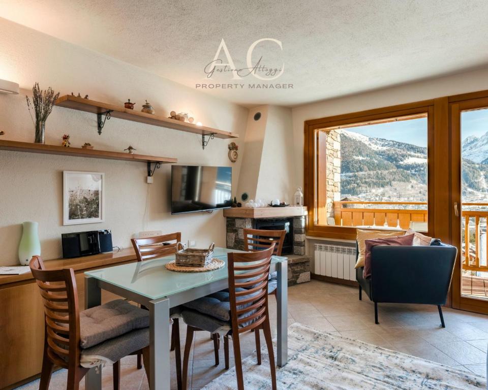 a kitchen and dining room with a table and chairs at Villa Nice View in Ponte di Legno