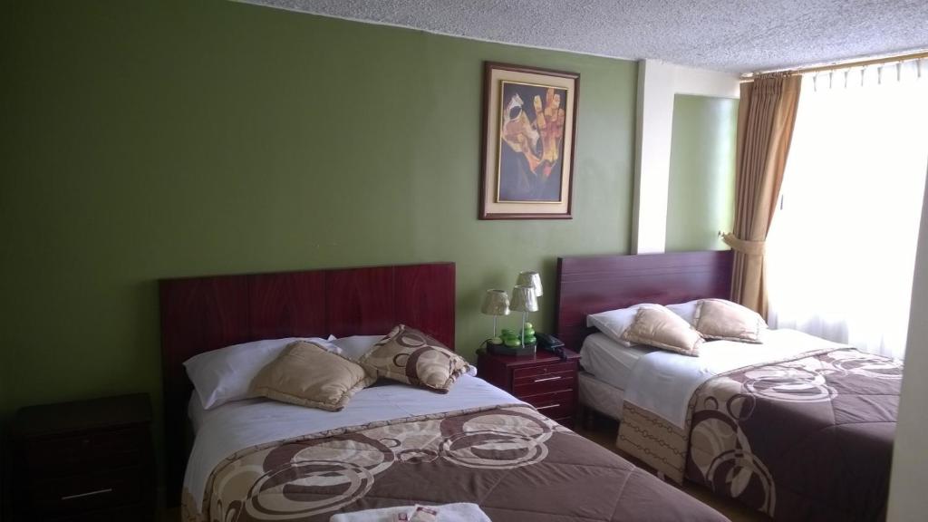 Postel nebo postele na pokoji v ubytování Hostal El Roble