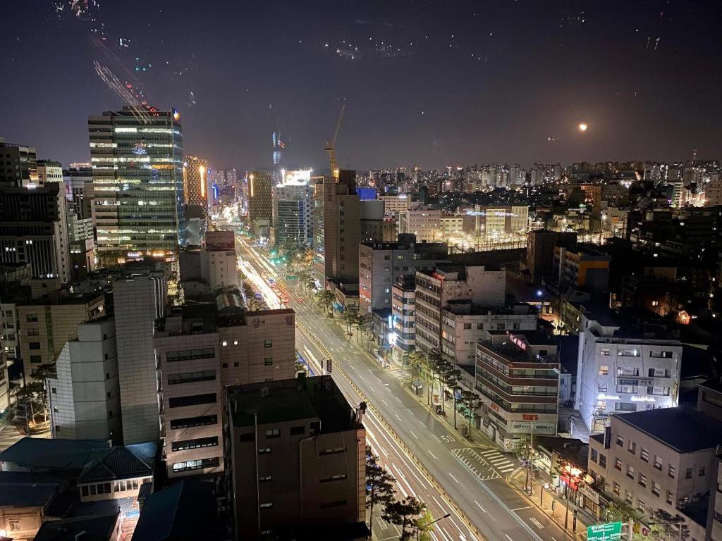 a city lit up at night with a highway at Chungmuro Merlin Hotel in Seoul