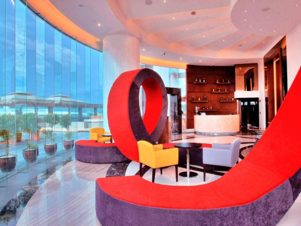 a lobby of a hotel with a large red sign at F1 Hotel Manila in Poblacion