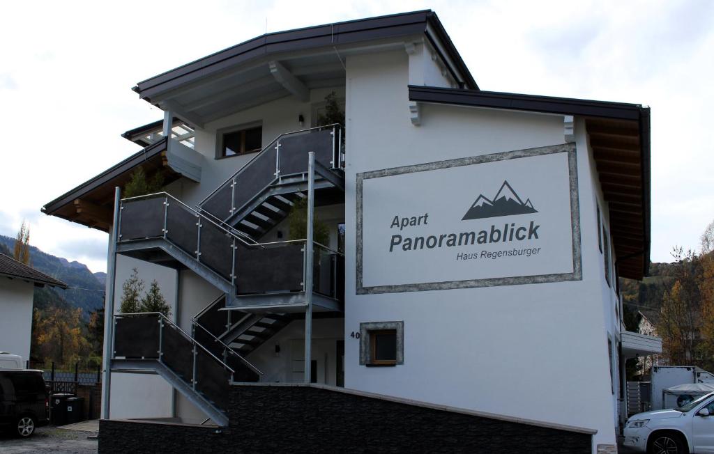 a building with a sign on the side of it at Apart Panoramablick 
