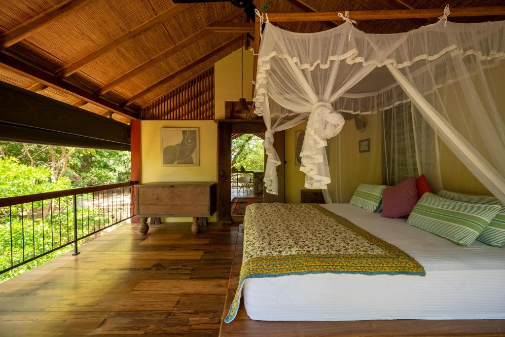 a bedroom with a bed with a canopy at The River House Dambulla by The Serendipity Collection in Dambulla