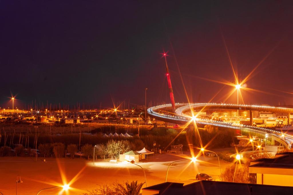 a city at night with lights on a bridge at "Casa incantevole" fronte mare Pescara in Pescara