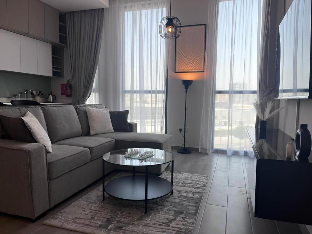 a living room with a couch and a table at Dar Alsalam - Premium and Spacious 1BR With Balcony in Noor 2 in Dubai