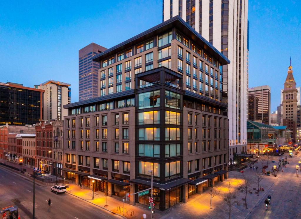 a tall building in a city with a street at Thompson Denver, by Hyatt in Denver