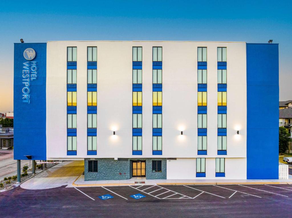 a large white building with blue and yellow windows at Hotel Westport Kansas City, Tapestry Collection by Hilton in Kansas City