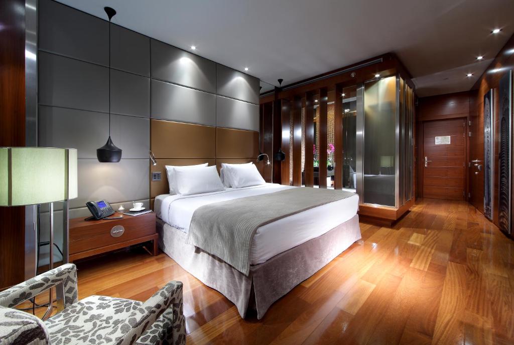 a bedroom with a large bed and a large window at Eurostars Madrid Tower in Madrid