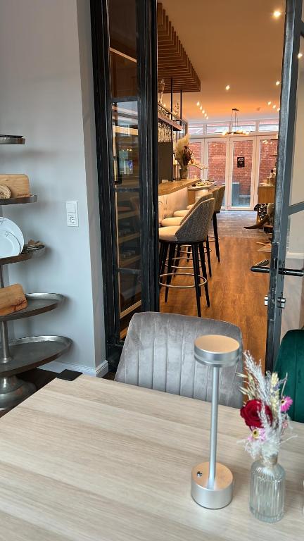 a room with a table and a dining room at Deichhotel Rose in Juist