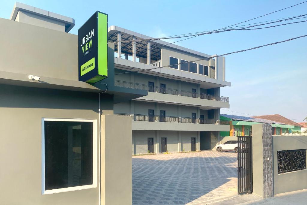 a building with a sign on the side of it at Urbanview Hotel AnD Lampung by RedDoorz in Lampung