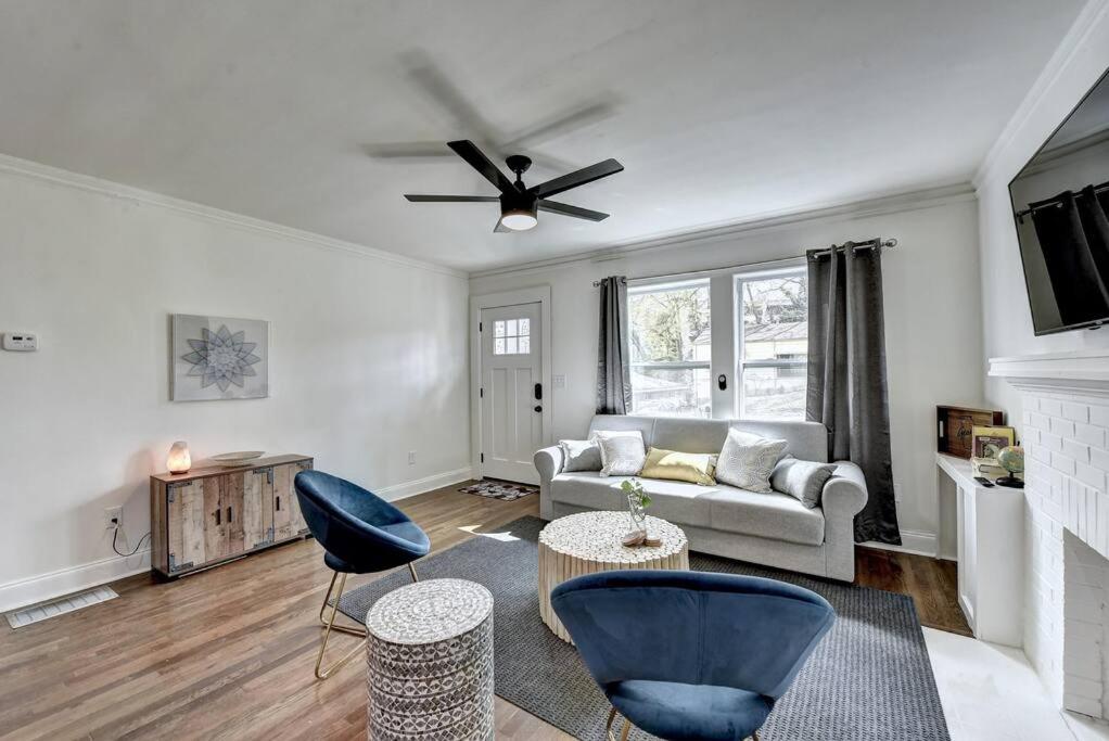 a living room with a couch and a ceiling fan at New Home in MidTown- Sleeps 11 For Rent in Atlanta in Atlanta