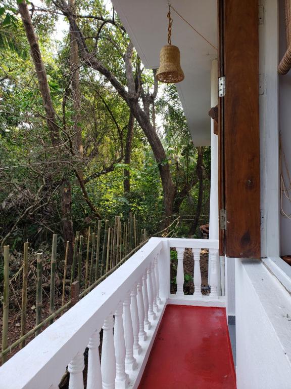 a stairway leading to a porch with a red carpet at Laxmi Happy Home in Querim Goa in Querim