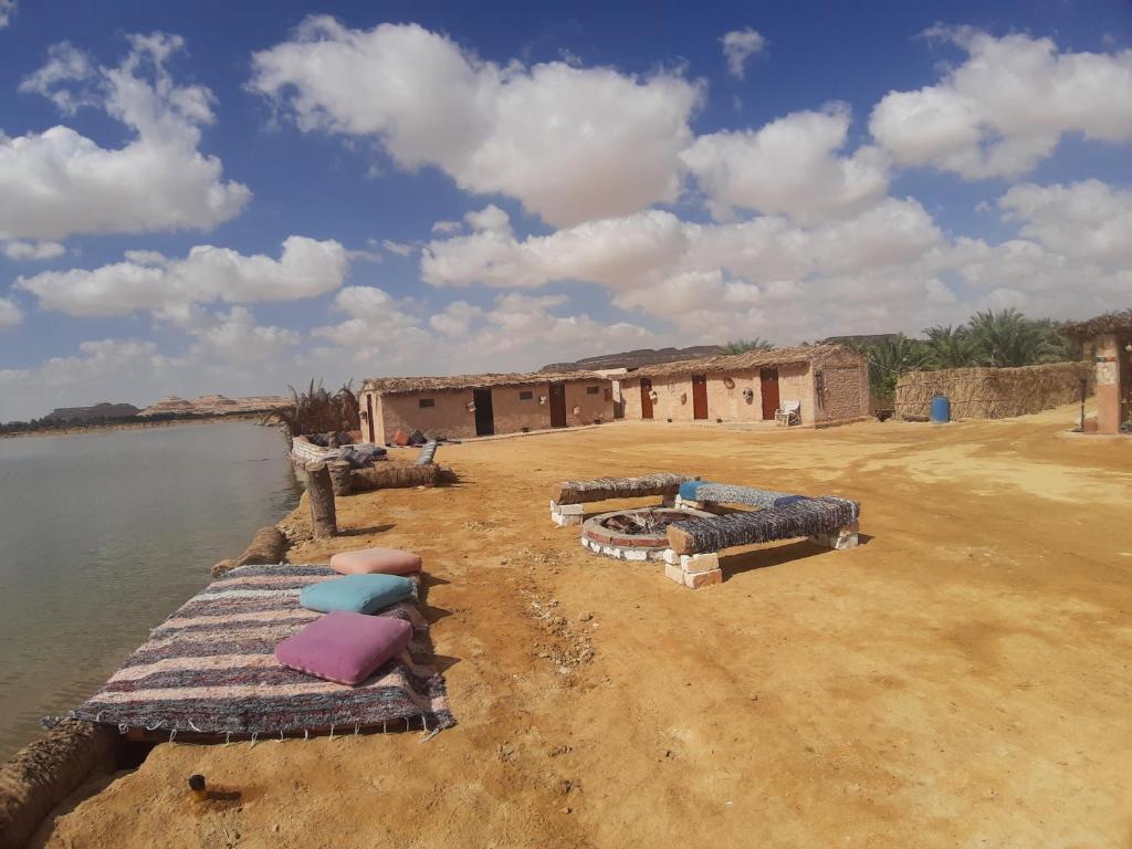 a building on the side of a body of water at M Biama Island in Siwa