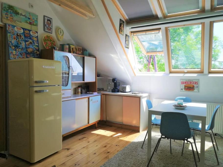 a small kitchen with a table and a refrigerator at Space Loft Graz in Graz