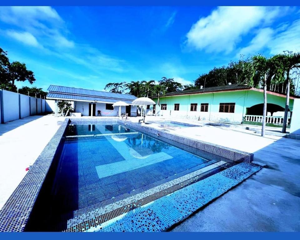 a swimming pool in front of a house at Dream Villa Homestay Kuala Nerang in Kuala Nerang