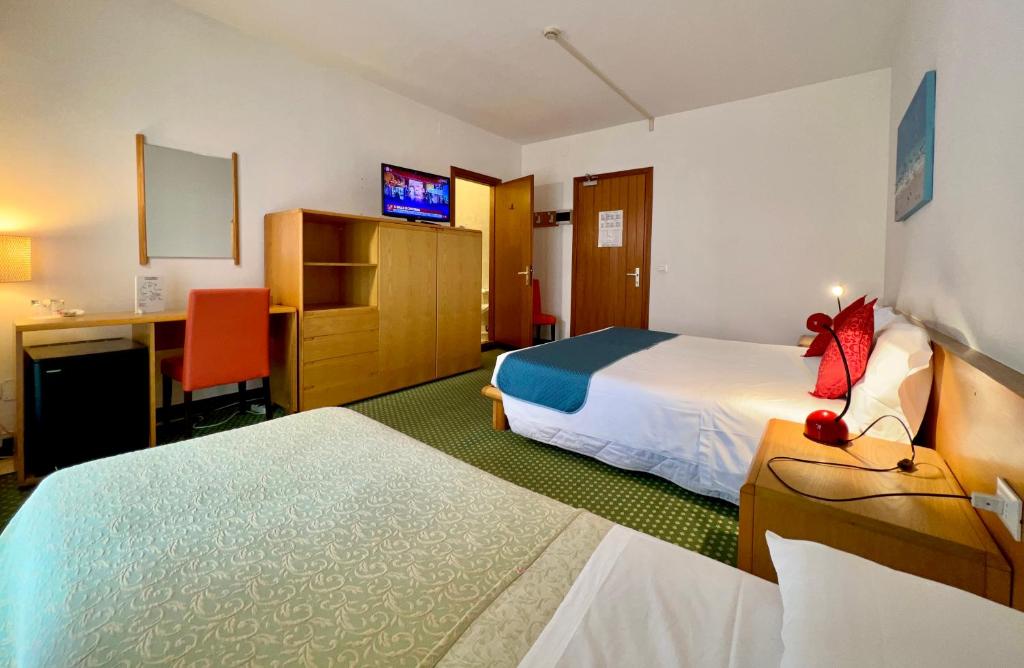Postel nebo postele na pokoji v ubytování Hotel Bella Venezia