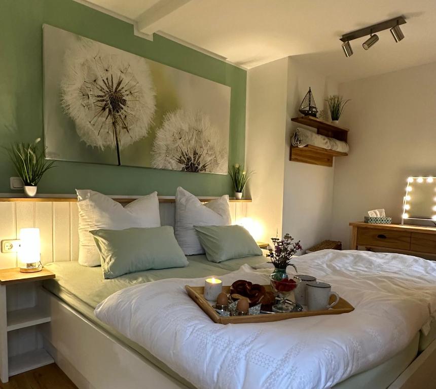 a bed with a tray of food on it at Ferienhaus Ella in Trautskirchen