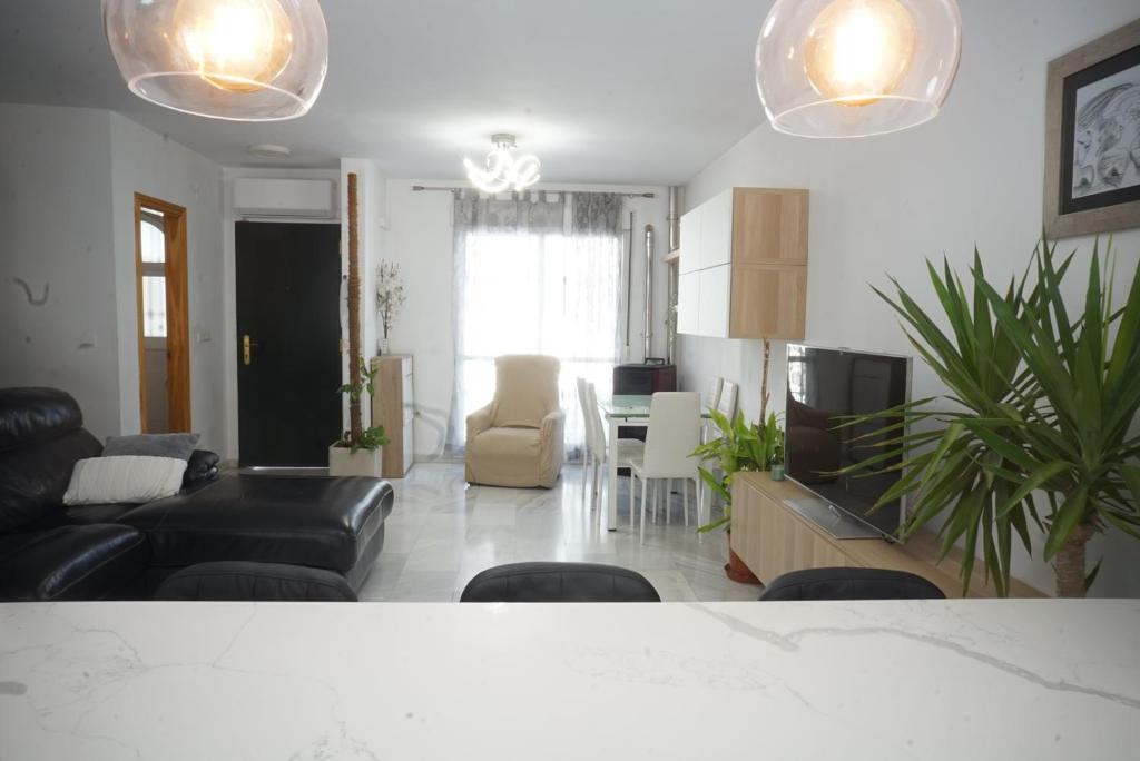 Gran casa ideal para familias في Atarfe: غرفة معيشة مع أريكة وغرفة طعام