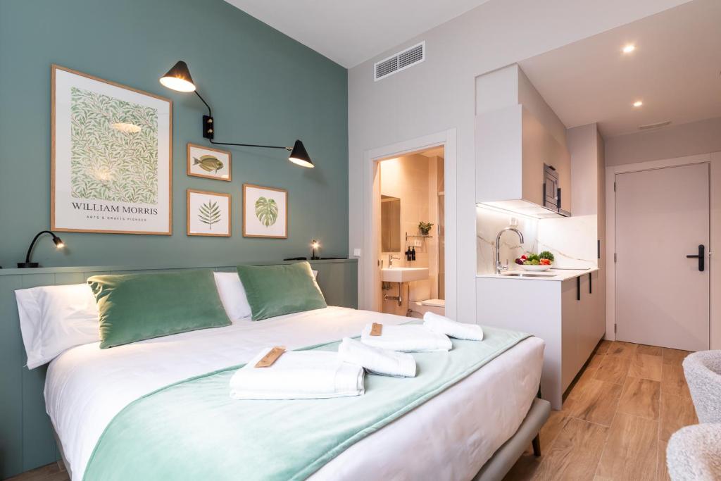 a bedroom with a bed with towels on it at Moontels Mercado de Ruzafa in Valencia