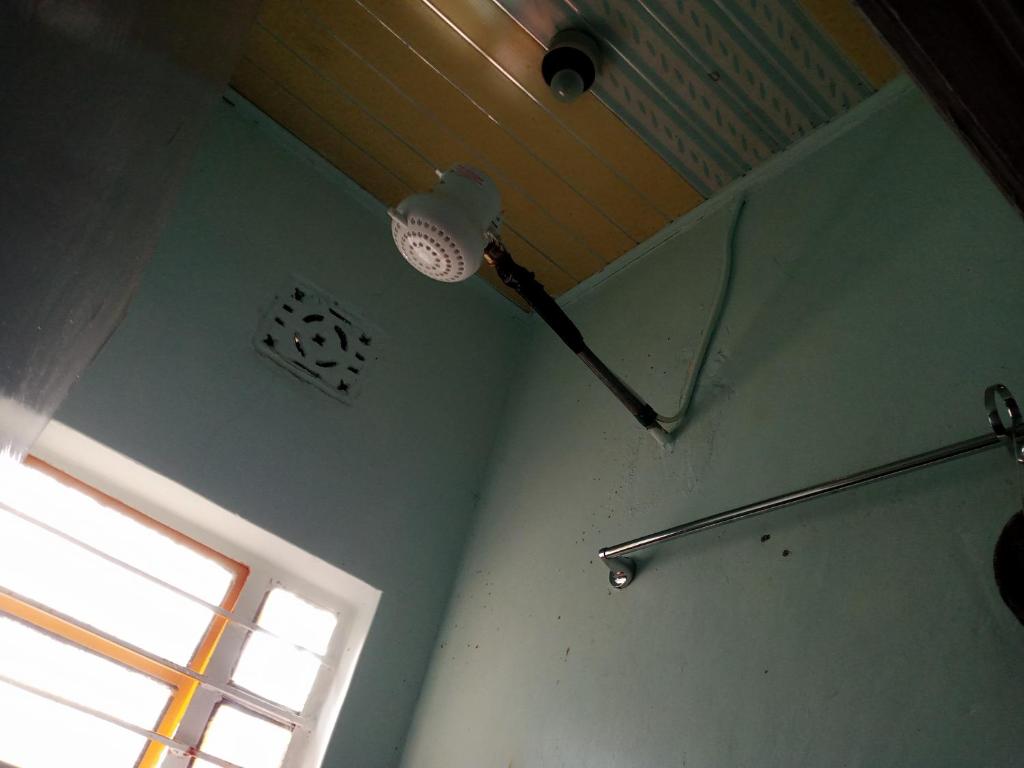 a room with a light on the ceiling and a window at Black gate in Nanyuki
