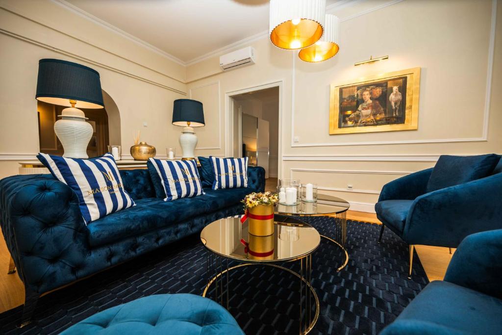 a living room with blue couches and a table at Luxury 3BDR Suite- Maison Imperial in Sarajevo