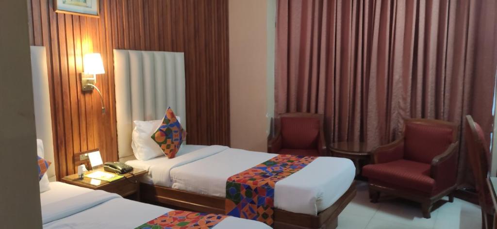 Postel nebo postele na pokoji v ubytování HOTEL CONCLAVE EXECUTIVE