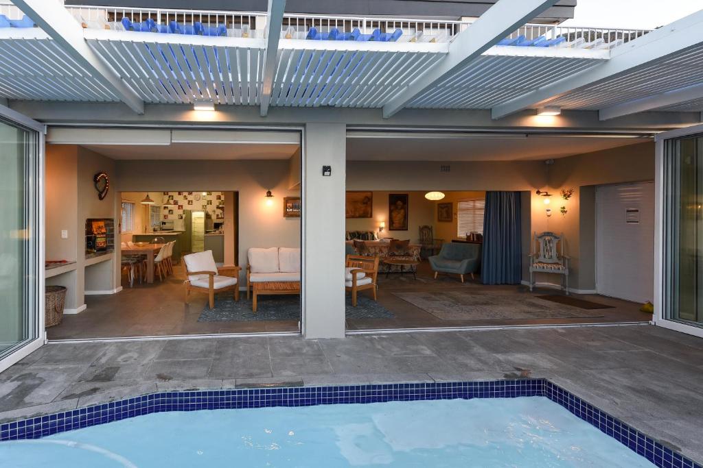 an open patio with a swimming pool and a house at Die Badhuis, for Fabulous living! Sleeps 4, Private pool in Gordonʼs Bay