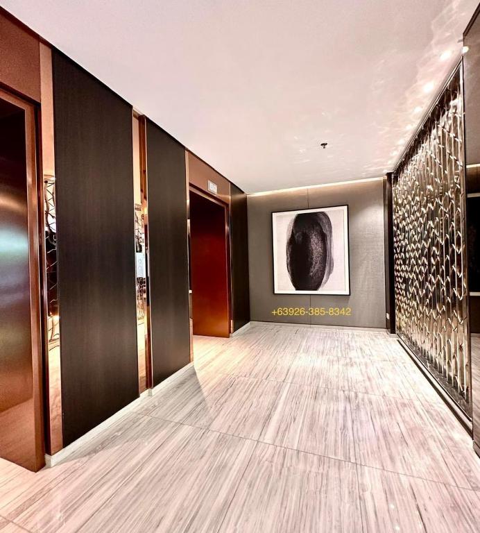a hallway of a hotel with a painting on the wall at LUXURY Condo BGC Taguig in Manila
