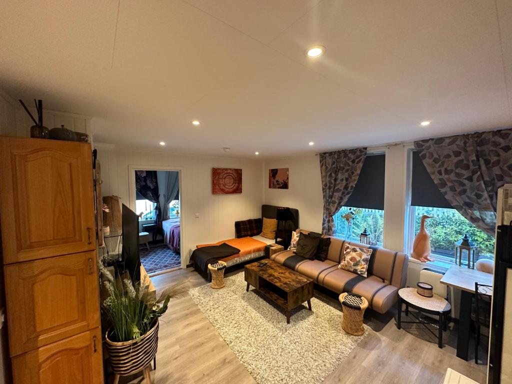 a living room with a couch and a table at Downtown Historical House with Renovated apartments in Ålesund