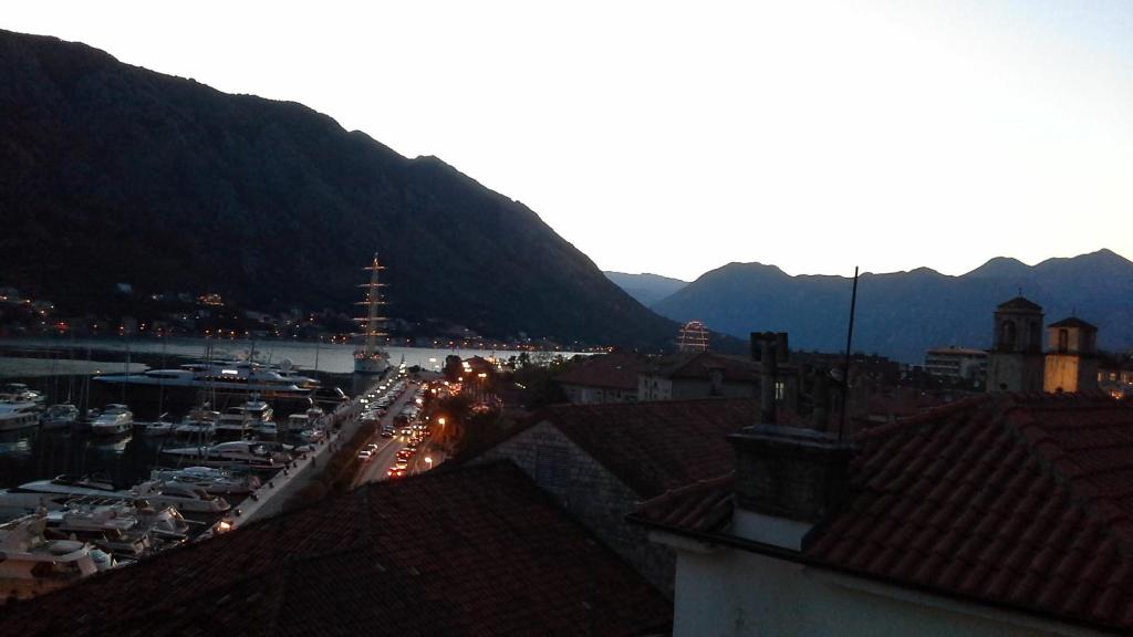 a view of a city with a harbor and mountains at Studios Kono in Kotor