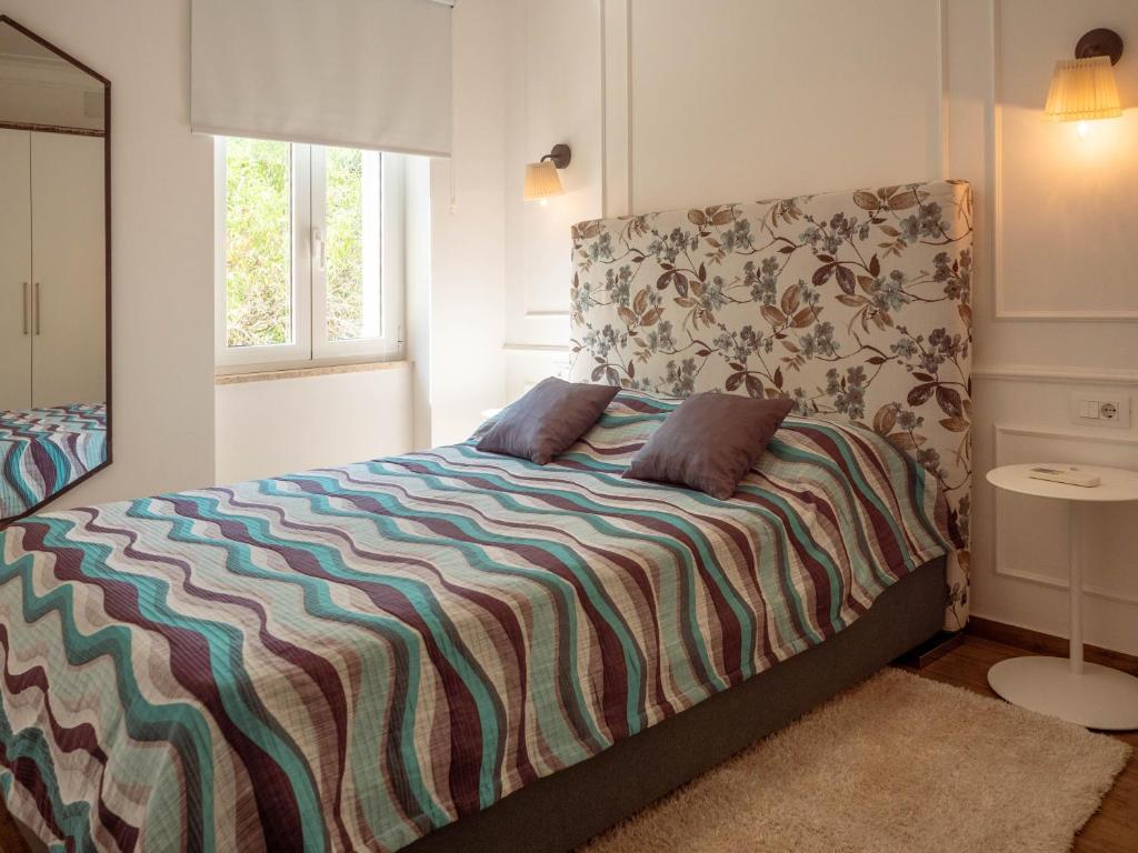 a bed with two pillows on it in a bedroom at Garden Rovinj in Rovinj