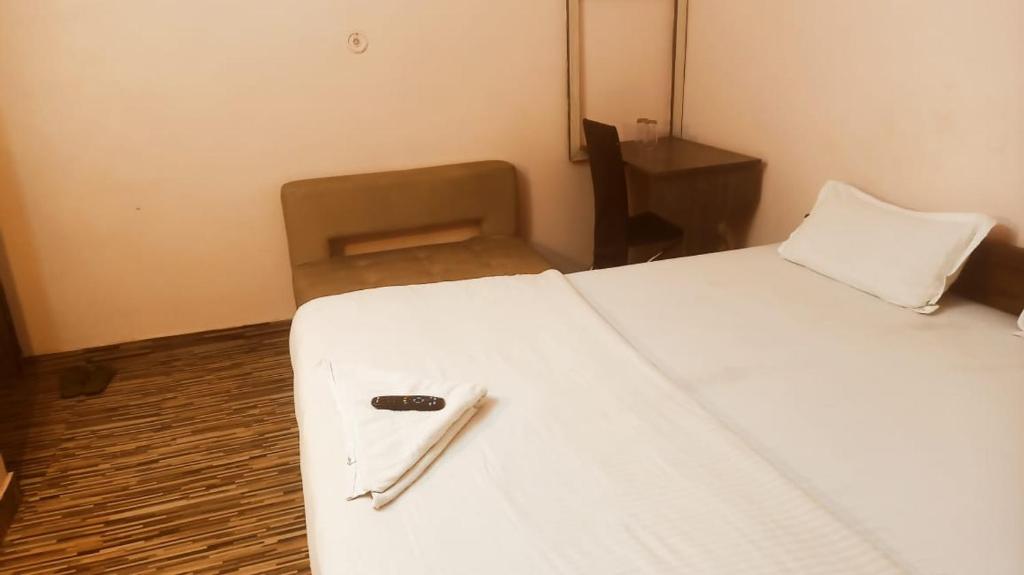 Säng eller sängar i ett rum på hotel darbar international