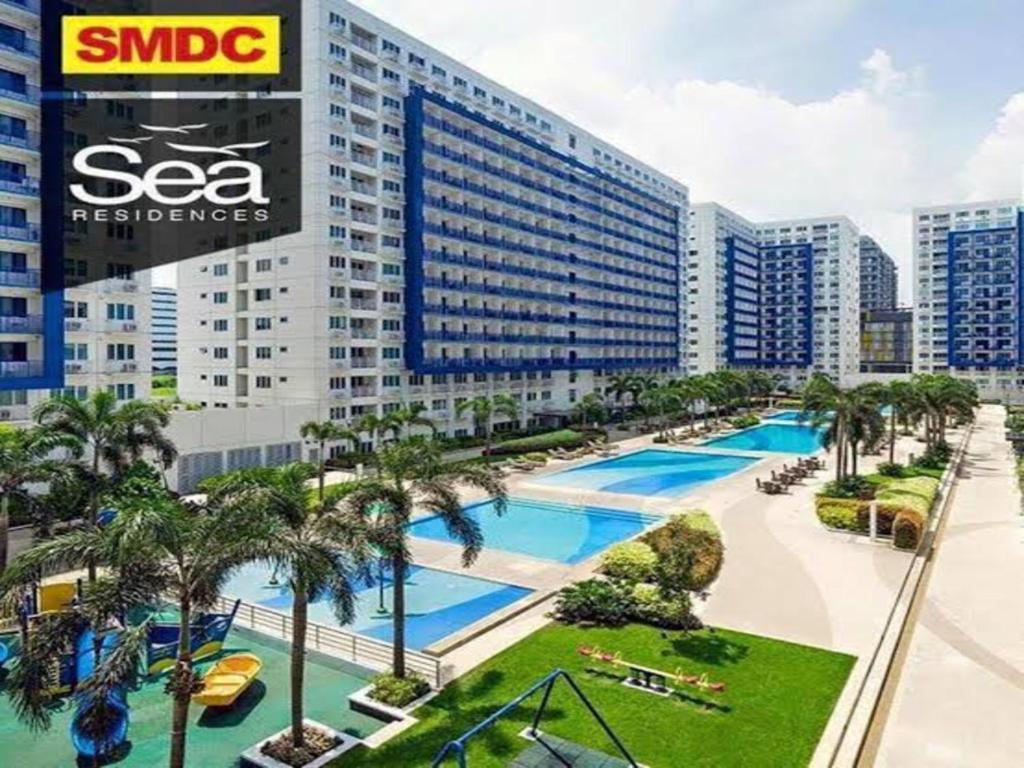 a view of a large building with a swimming pool at Sea Residences in Manila
